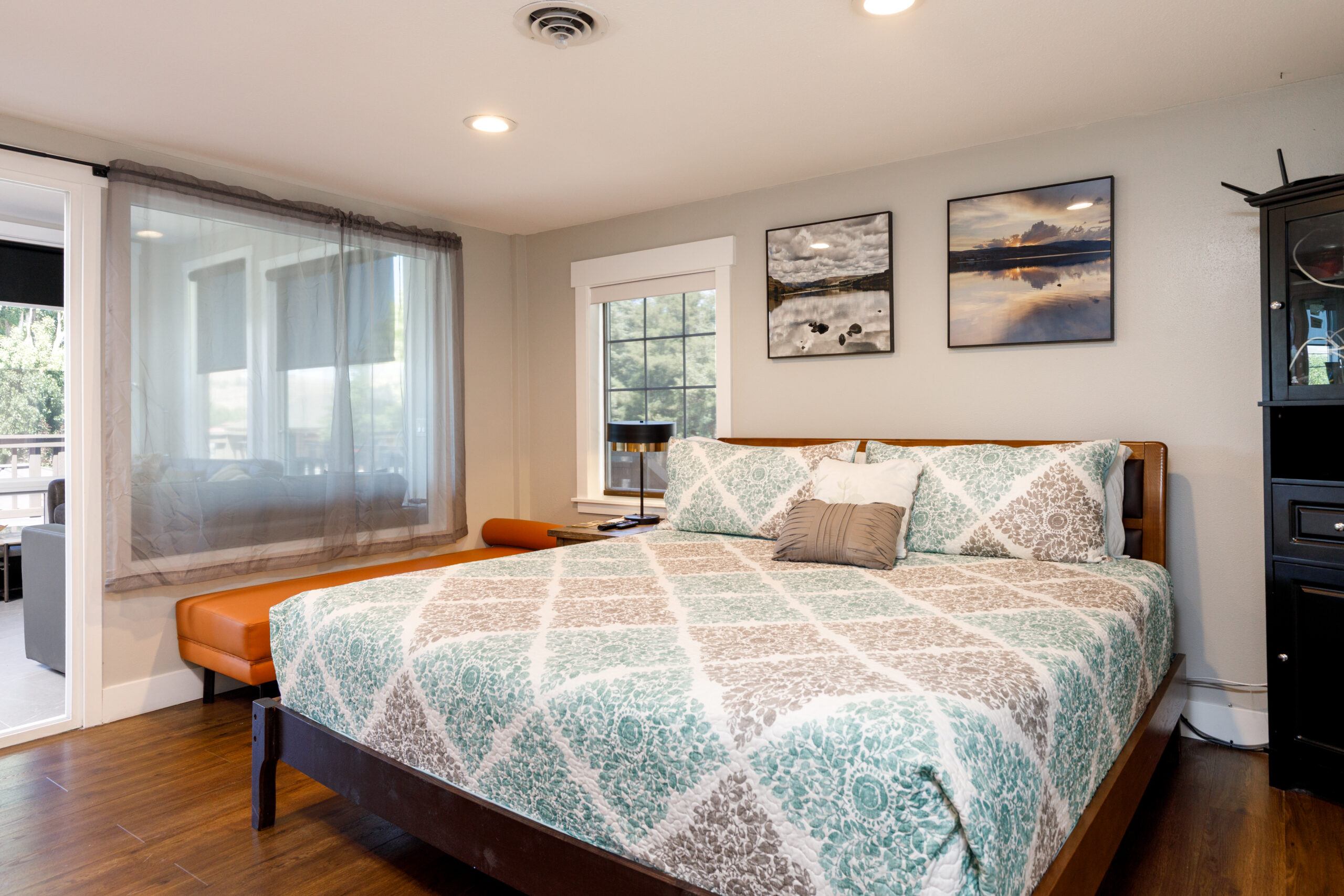 Bedroom with patterned bedspread, wall art, and natural light in Soap Lake Resort unit