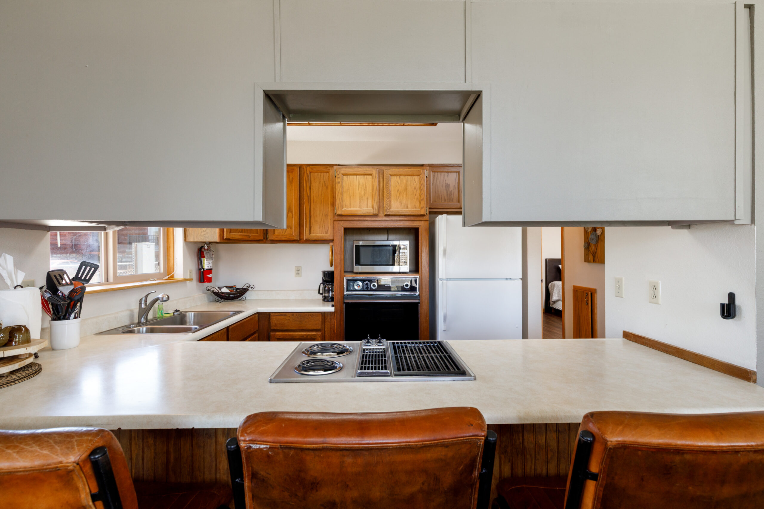 Fully equipped kitchen with counter seating in the Beach House at Soap Lake Resort